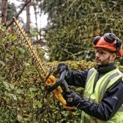 DeWalt DCMHT563P1-GB 18V XR Cordless Hedge Trimmer (with 5Ah Battery & Charger) -Greenworks Sale Shop dewalt dcmht563 hedge trimmer lifestyle 3